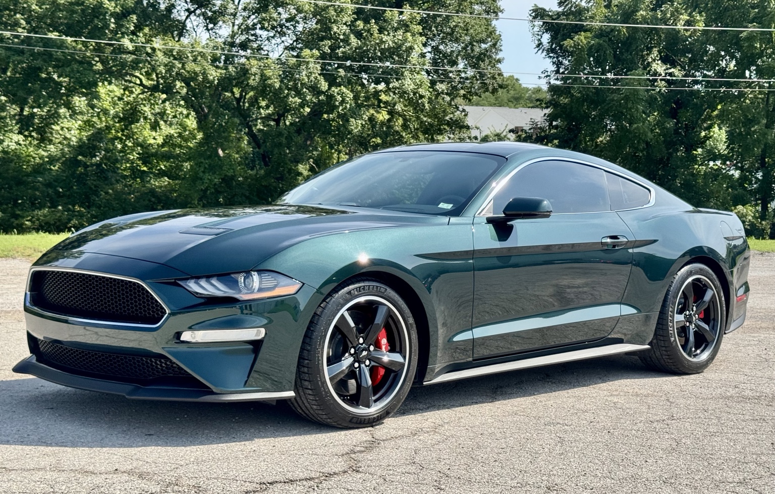 Completed dark green 2020 Bullitt Mustang photographed from the front three-quarter angle outdoors