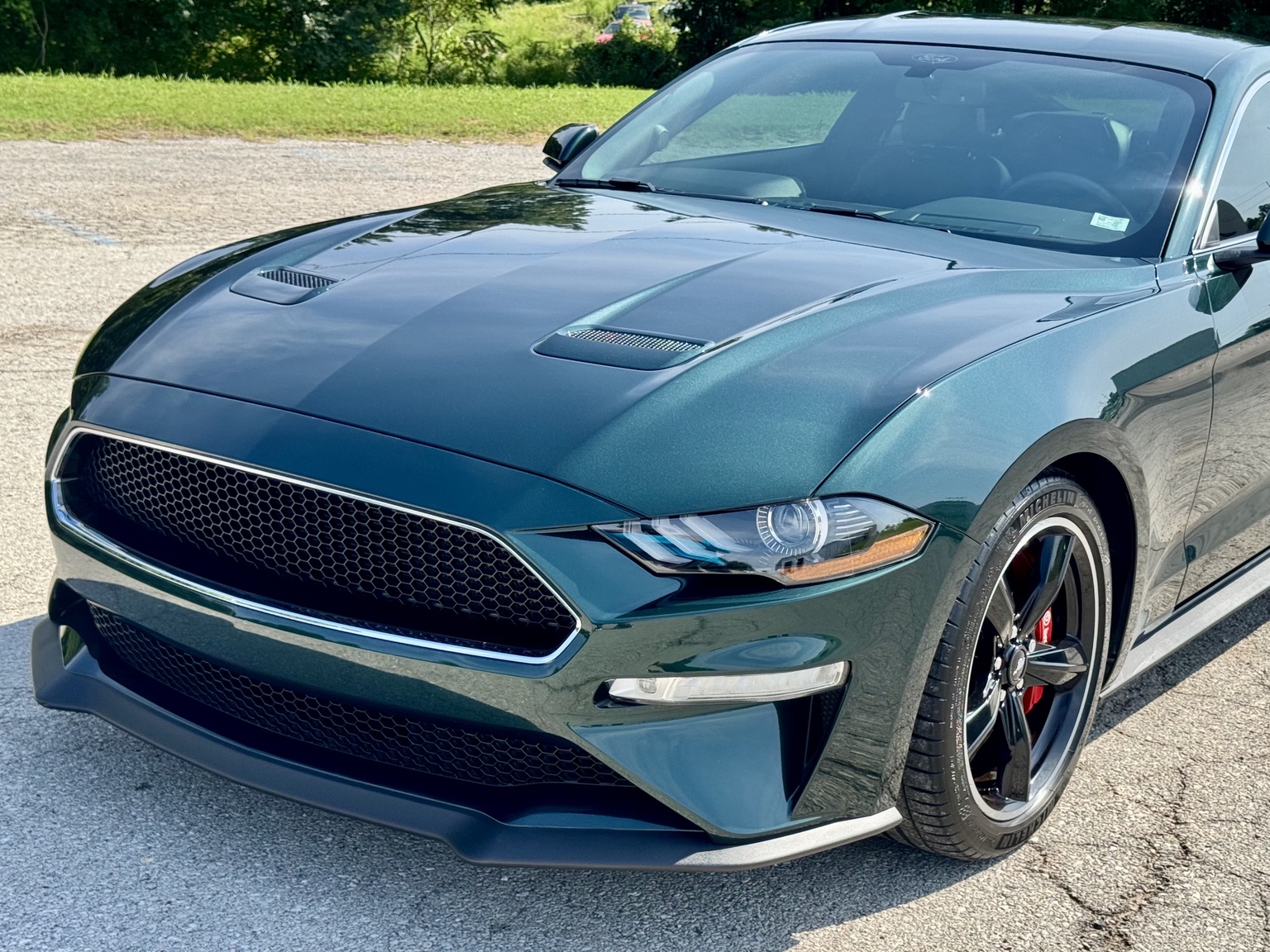 Closer front-quarter view of the dark green Bullitt Mustang