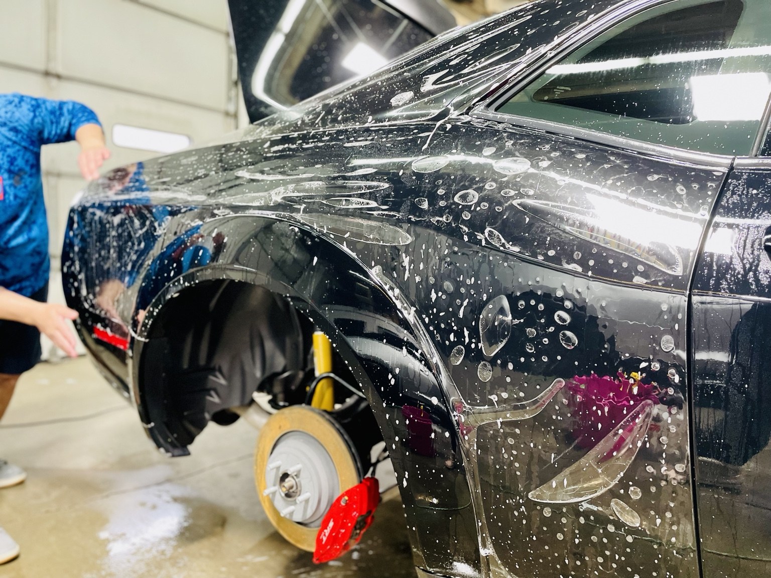 Paint protection film installation on a black Mustang at STL Auto Defenders