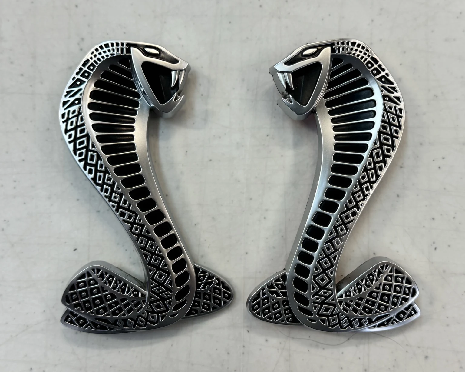 The Shelby’s two original chrome Cobra fender emblems removed and preserved for reinstallation
