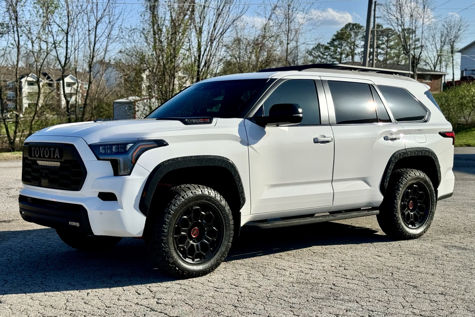 White Toyota SUV photographed from the front with side glass visible