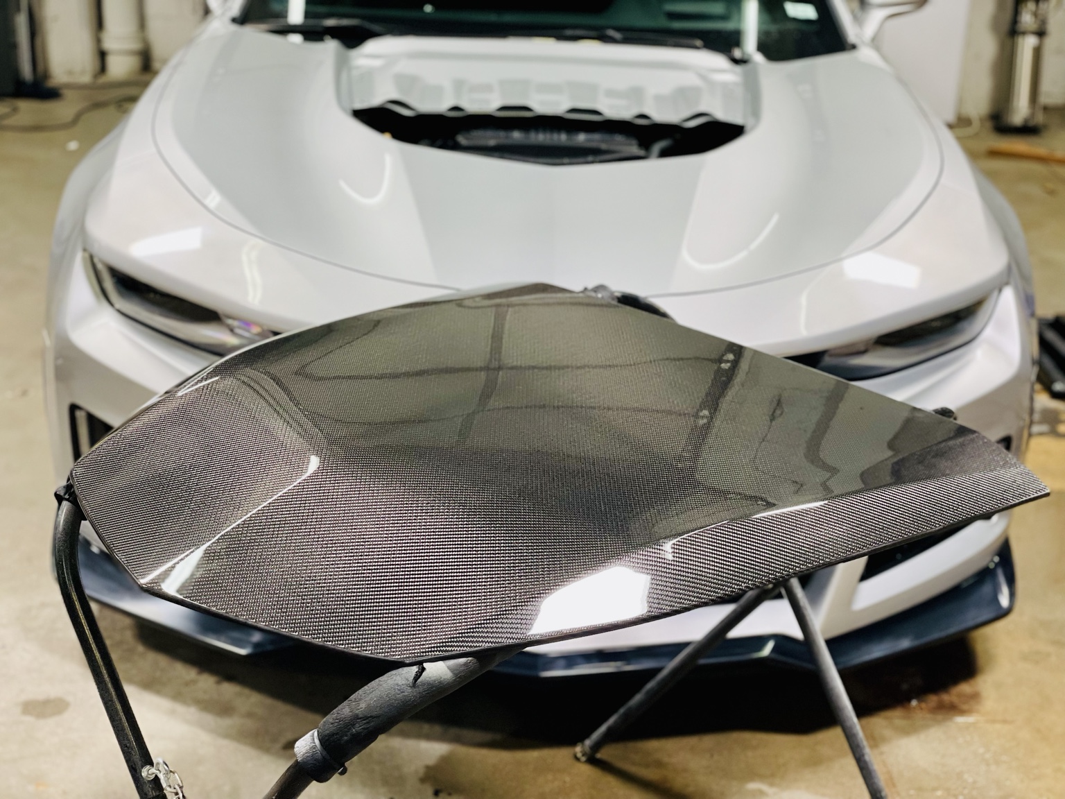 Silver Camaro ZL1 in the shop with the center carbon-fiber section removed