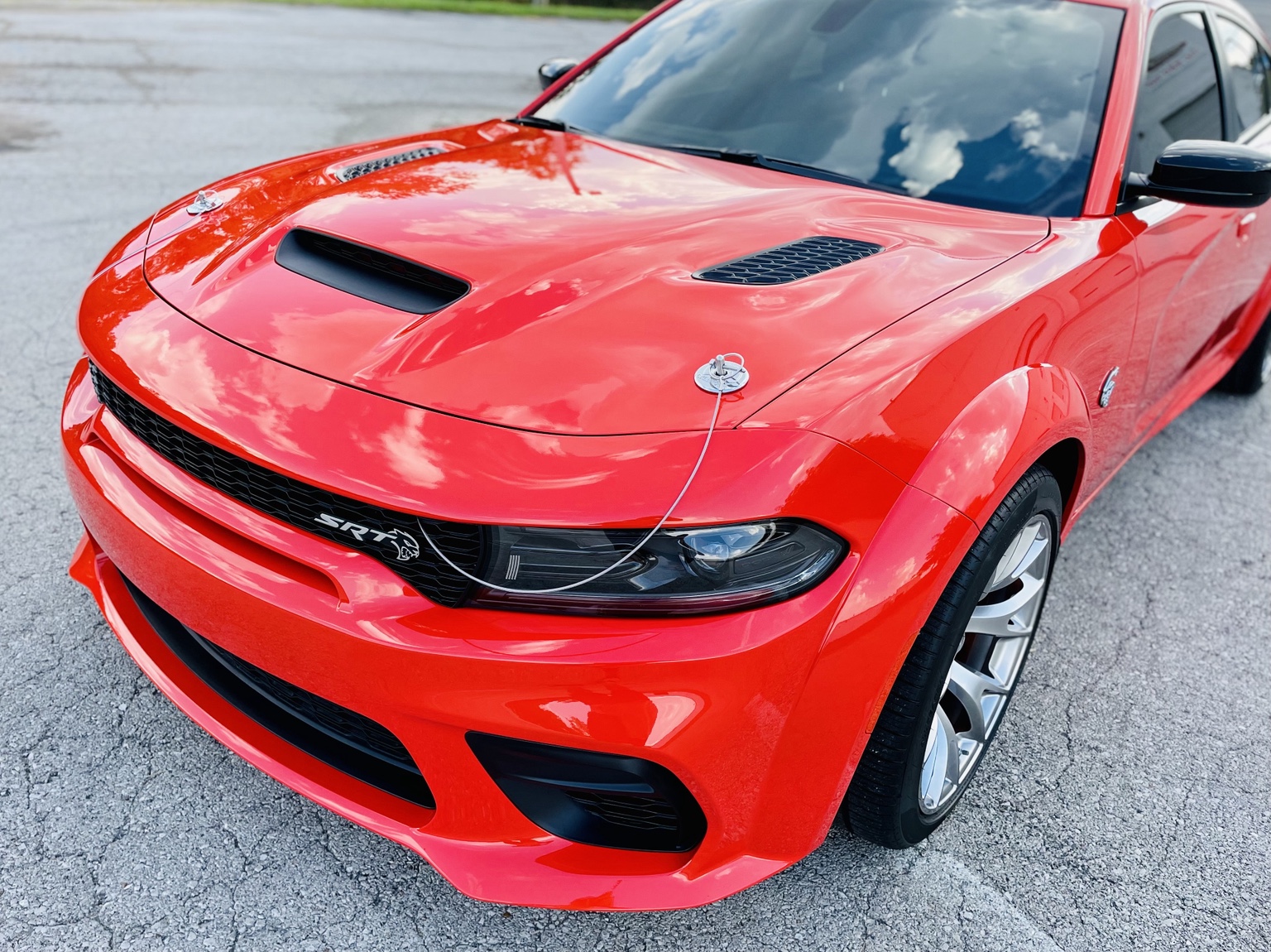 Red Dodge Charger photographed from the front three-quarter angle