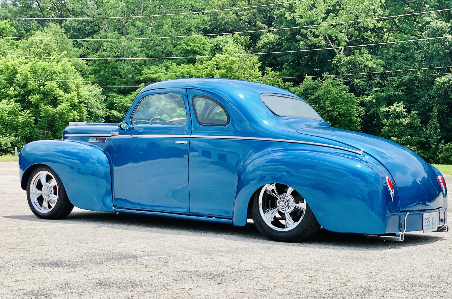Blue classic coupe with glossy paint and clear reflections