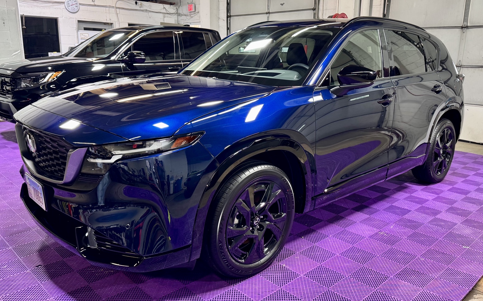 Blue Mazda CX-90 inside the STL Auto Defenders installation shop