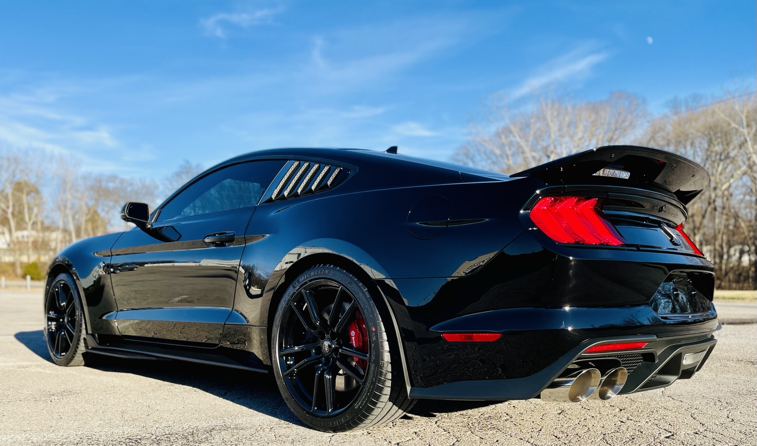 Glossy black Shelby Mustang photographed outdoors after finish work