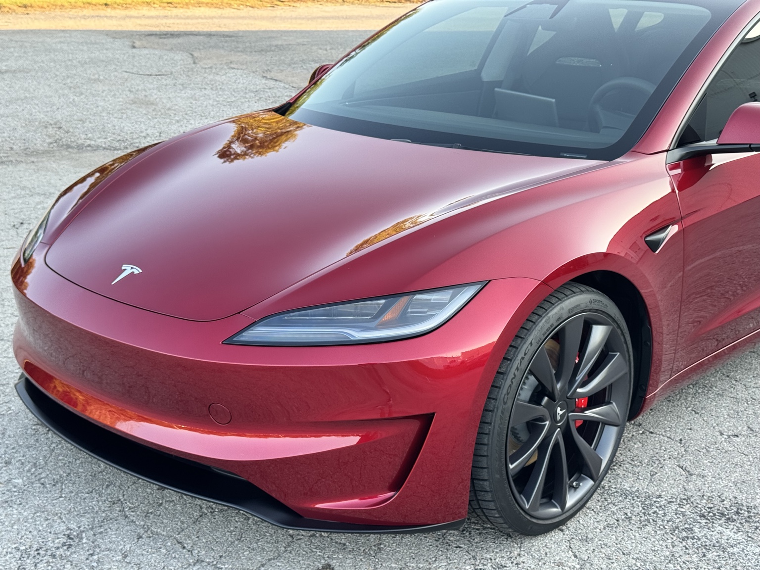 Red Tesla Model 3 after full front paint protection film installation at STL Auto Defenders in Arnold, Missouri
