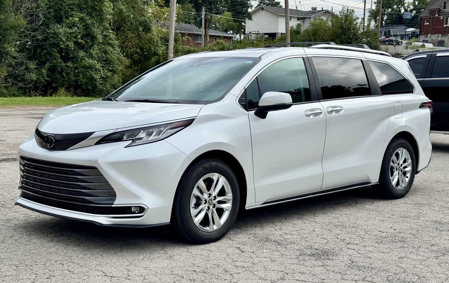 White Toyota Sienna photographed from the front three-quarter angle outside STL Auto Defenders
