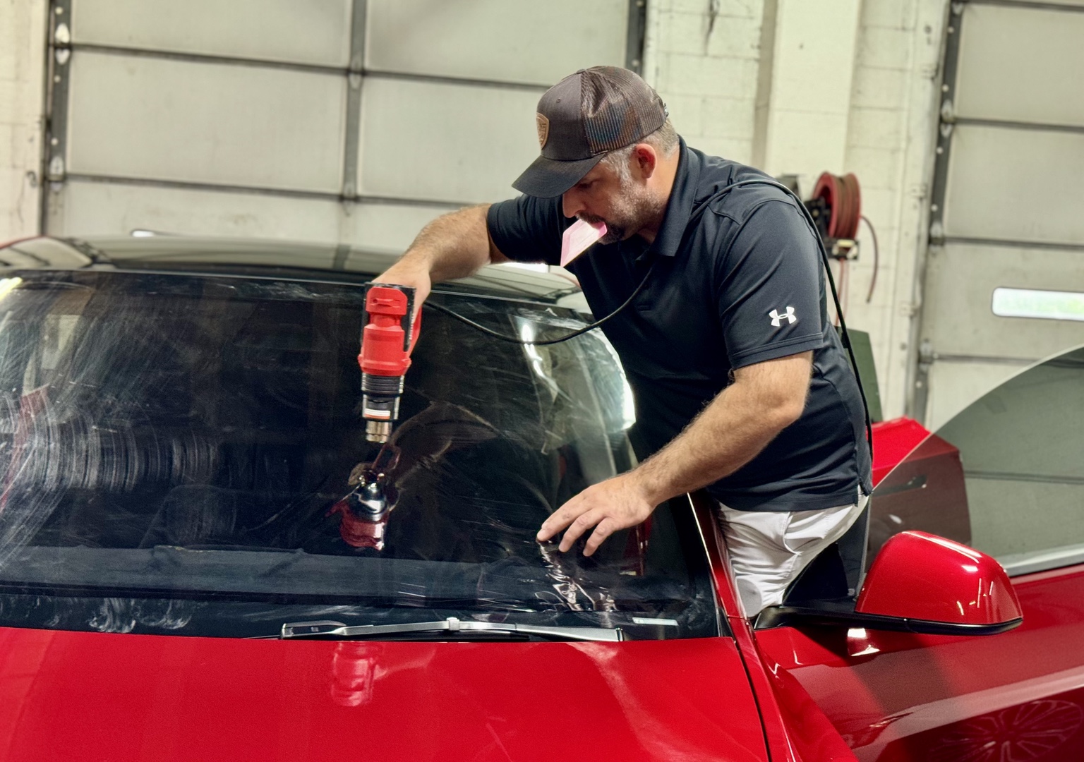 Hands-on automotive glass protection work at STL Auto Defenders